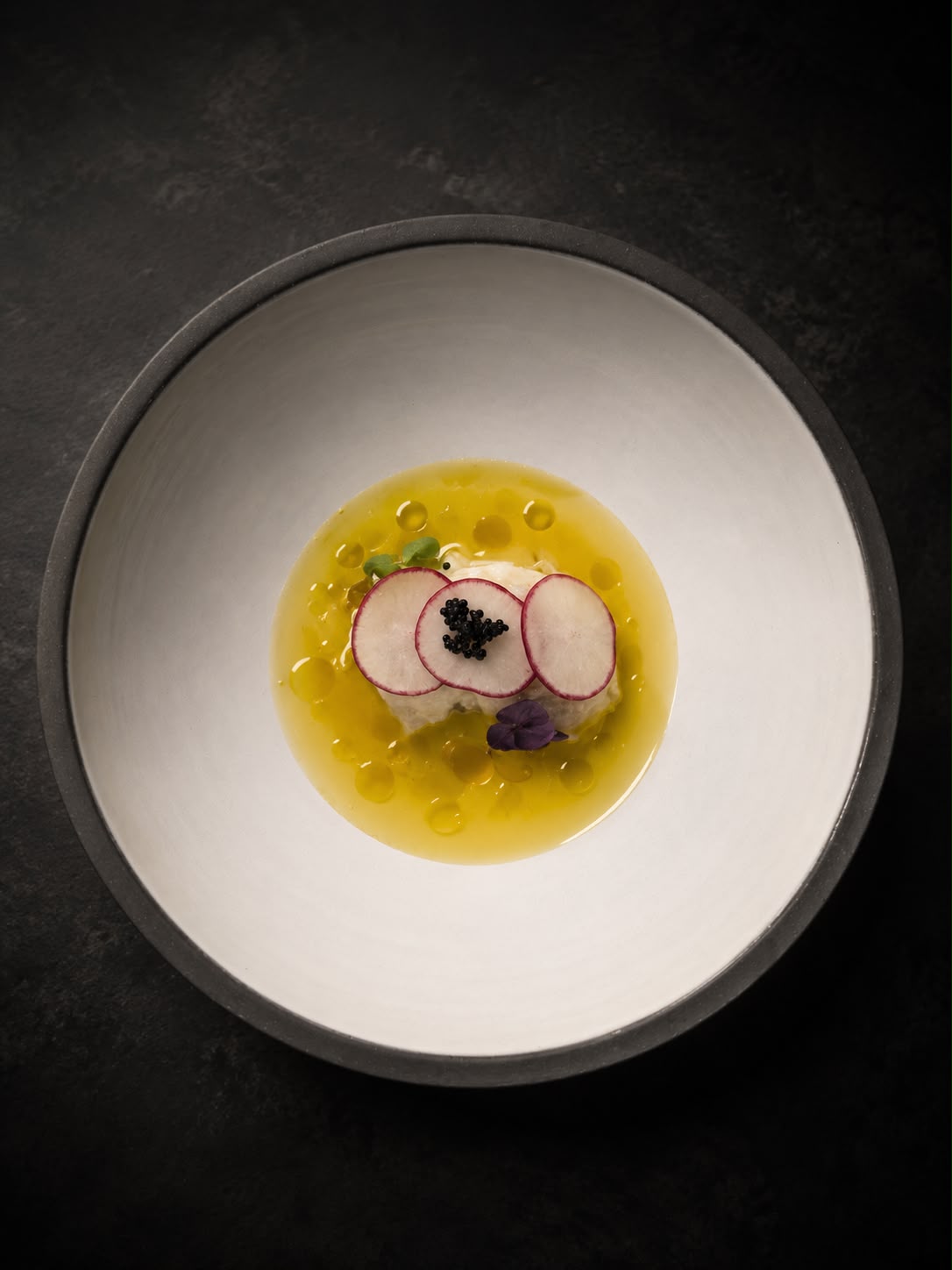 A refined course with radish, caviar and golden dressing
